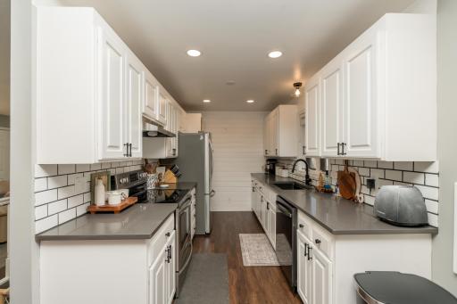 Updated kitchen with new cabinets, countertops, lighting, flooring, appliances and backsplash. *Not pictured on the other side of the refrigerator is a pantry!