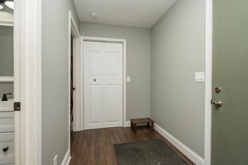 Back (garage) entry that leads to 1/2 bath (main floor), laundry room and closet