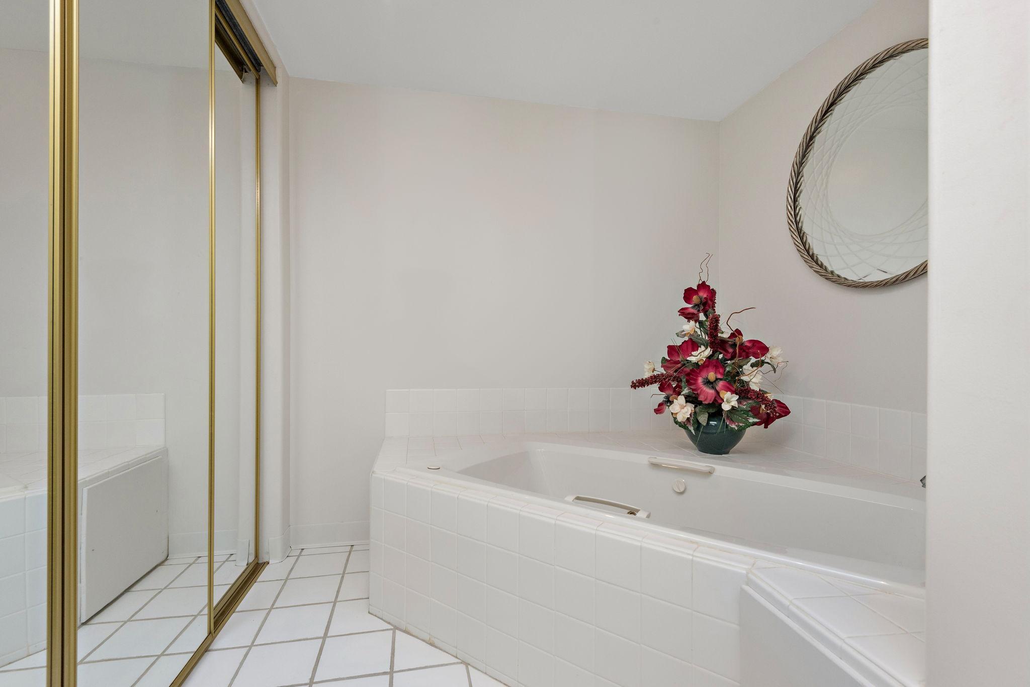 Lower bath has a jetted tub for relaxing, separate shower and spacious closet for storage needs.