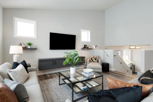 Photos are from previous, similar model. The options, features and color scheme will vary. Actual home will have gas fireplace in lieu of floating shelf. The vaulted ceiling reaches dramatic heights, allowing for an open, airy atmosphere.