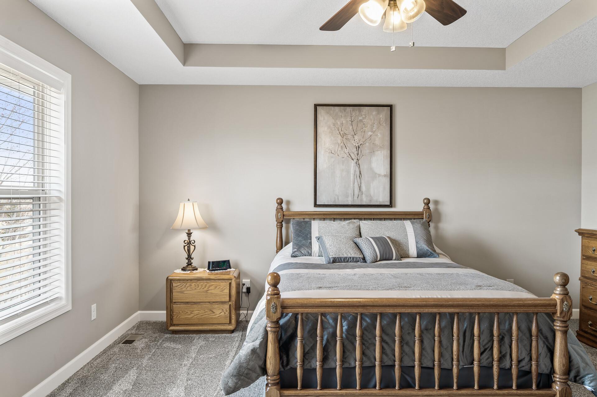 A sleek ceiling fan adds comfort and style to the primary bedroom.