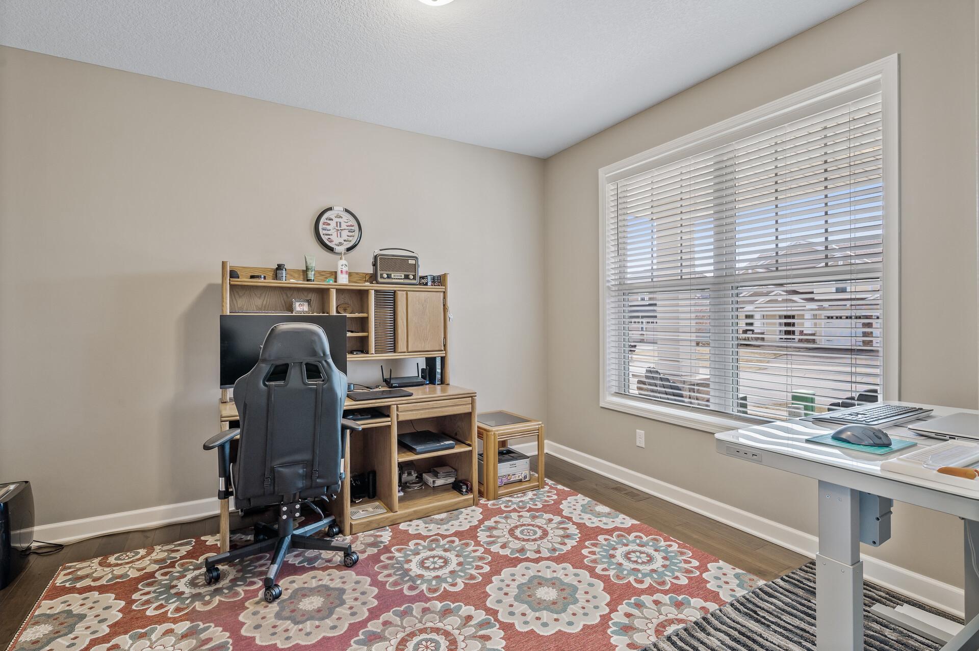 Conveniently located on the main level is a spacious office space or flex room.