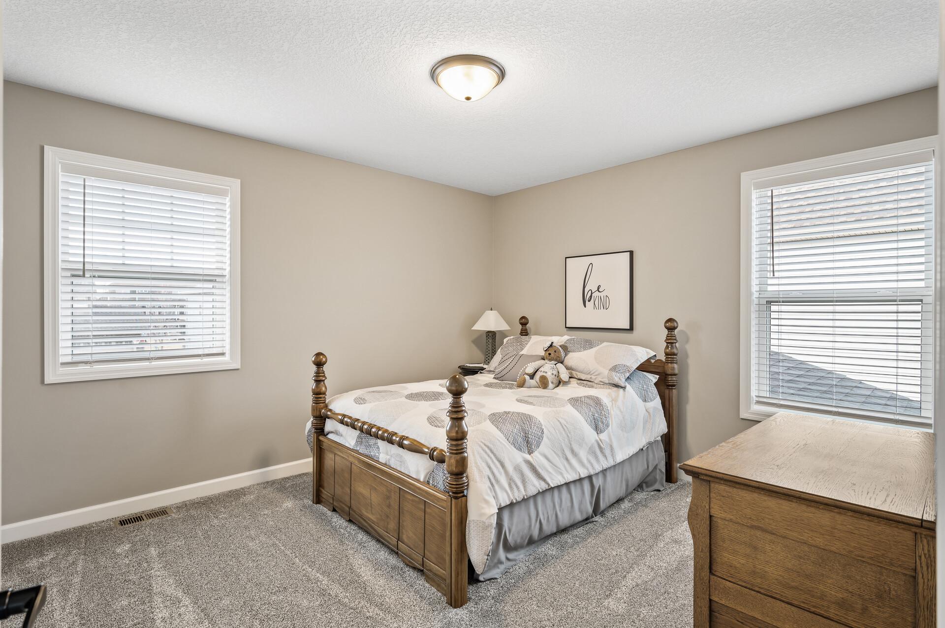 Third upper level bedroom also offers plush carpet, neutral tones and abundant natural light with multiple windows.