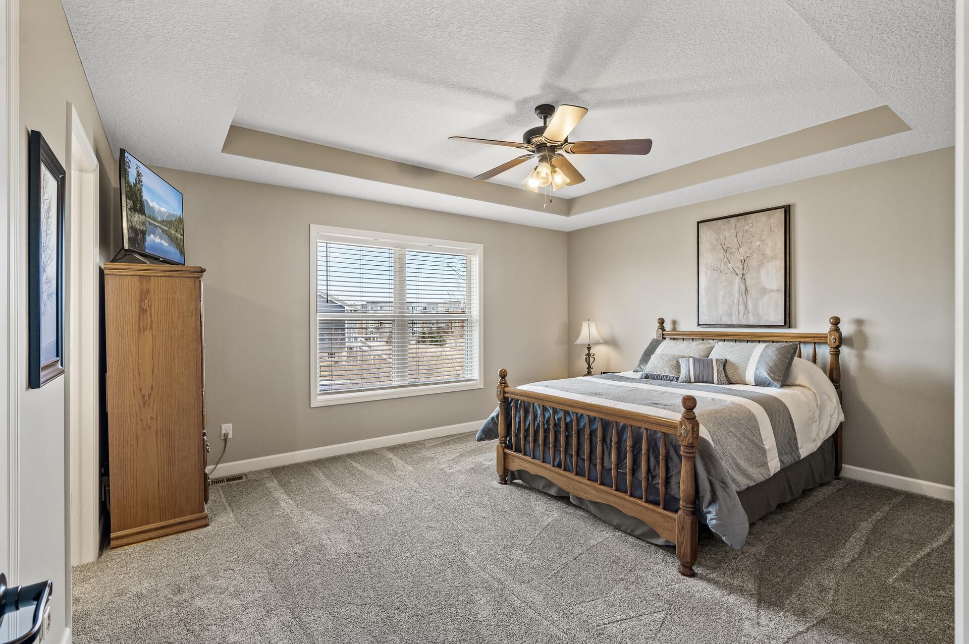 The primary bedroom oasis is spacious and delivers architectural details with the tray ceiling.