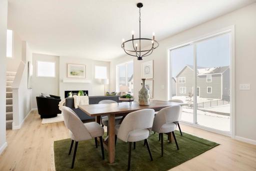 The dining room seamlessly opens to an 8-foot patio door, enhancing the flow between indoor and outdoor living.
Photos are from previously built home; options and features will vary.