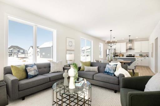 The open-concept design of the home is enhanced by strategically placed windows, allowing natural light to flood the space and create a bright, welcoming atmosphere. Photos are from previously built home; features and options will vary.