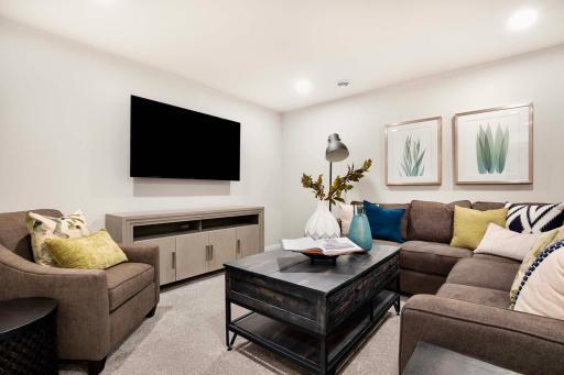 The lower level family room offers an ideal area for entertainment, or a cozy retreat. It will easily accommodate a variety of activities, from movie nights to game rooms. Photos are from previously built home; options and features will vary.
