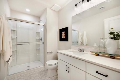 Lower level bathroom is perfect for over night guests. Photos are from previously built home; options and features will vary.