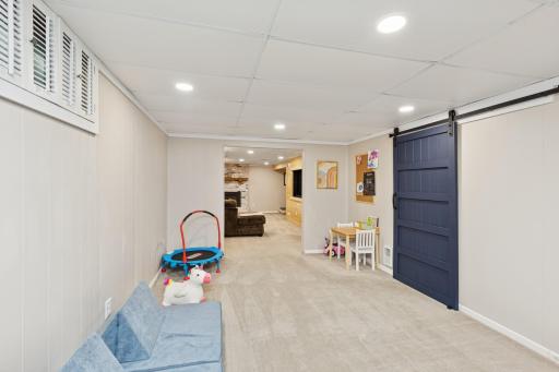 Lower level flex room w/work space behind barn door