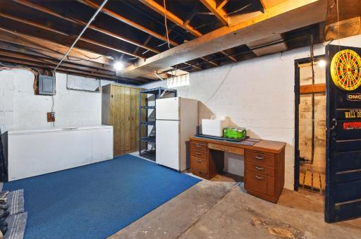 The basement is super spacious, and this deep freezer & fridge are staying with the home!