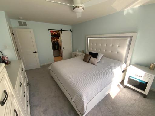 Barn door into the primary walk in closet.