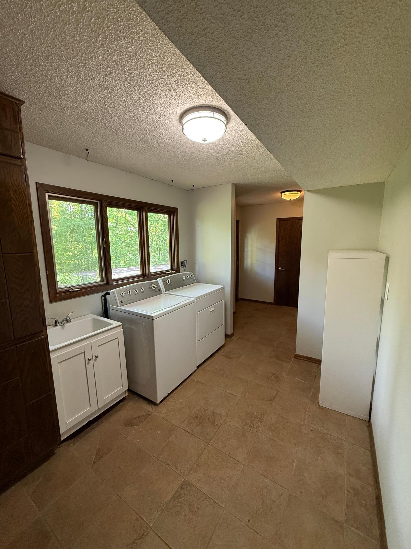 Laundry room is 11' x 8.5' with lots of storage and natural light!