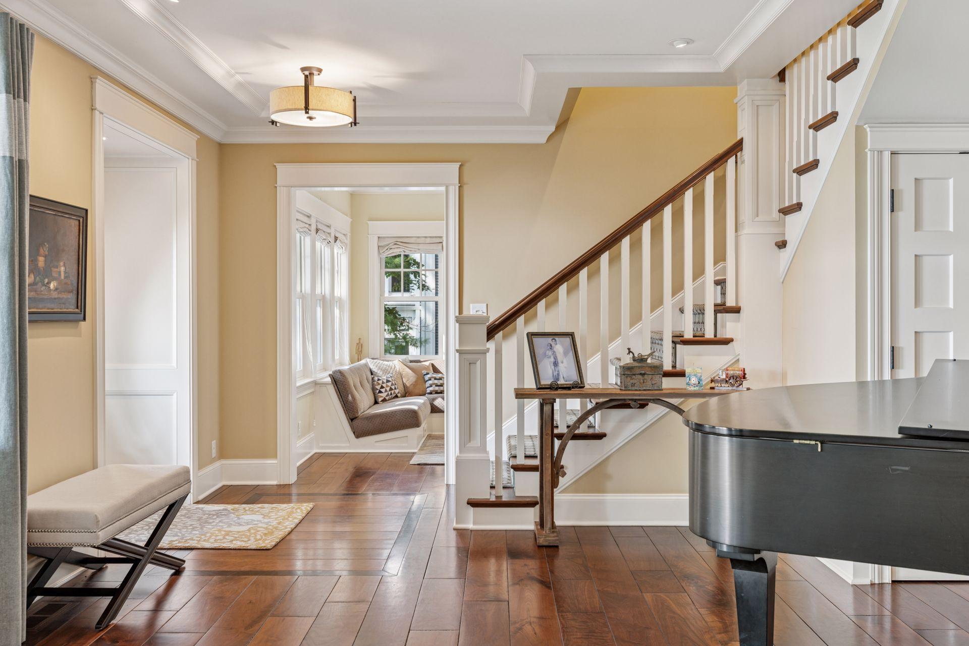 33x16 Fully Renovated Main Level Living room with new south and west facing Marvin Ultimate wood windows, 8-inch solid walnut floors, custom enameled wood work, custom staircase, and double-sided Gas Fireplace.