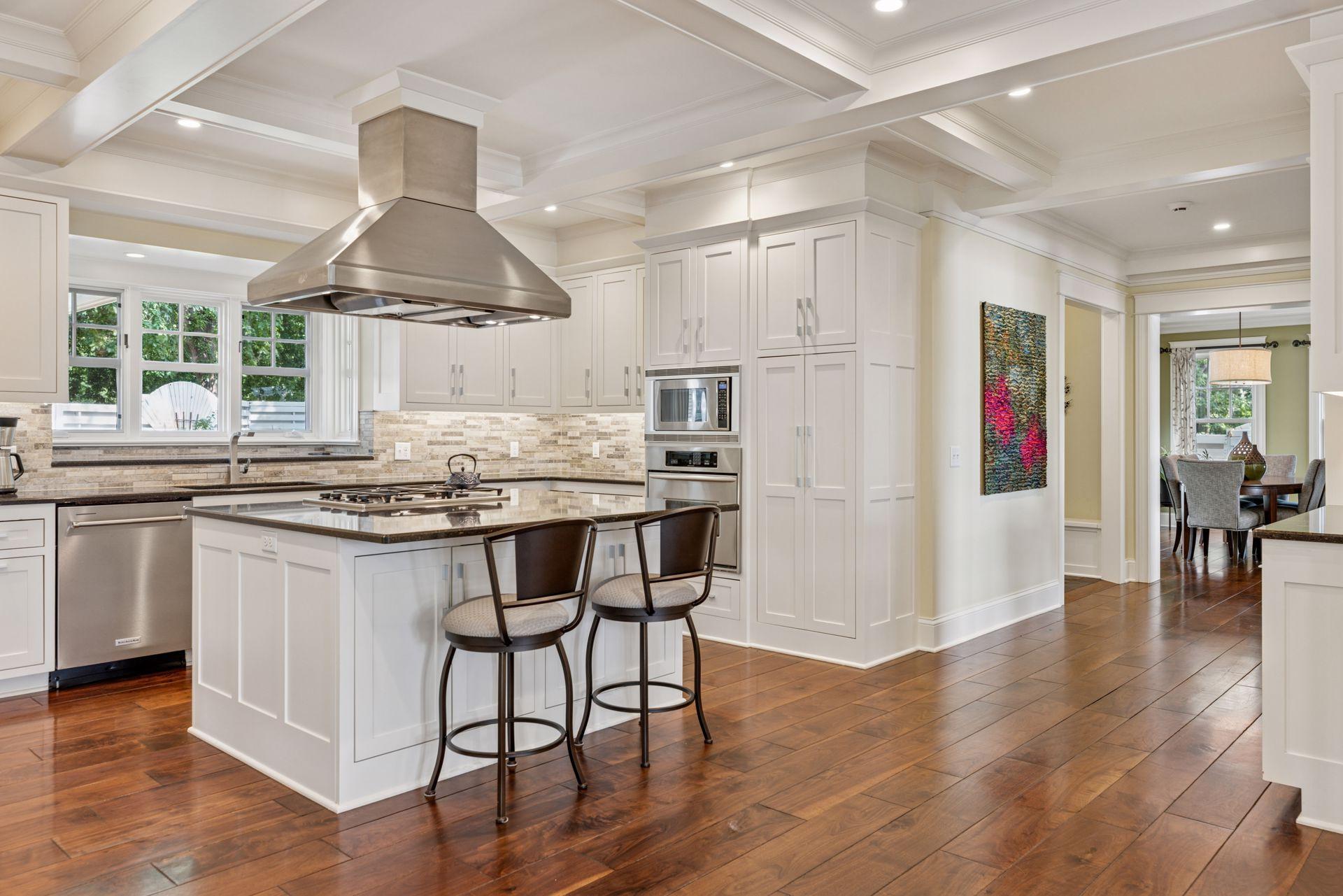 33x24 Fully Renovated Main Level Kitchen with new east, west and north-facing Marvin Ultimate wood windows, 8-inch solid walnut floors, custom enameled Danners cabinetry, coffered ceilings and mill work, Granite countertops and stainless appliances.
