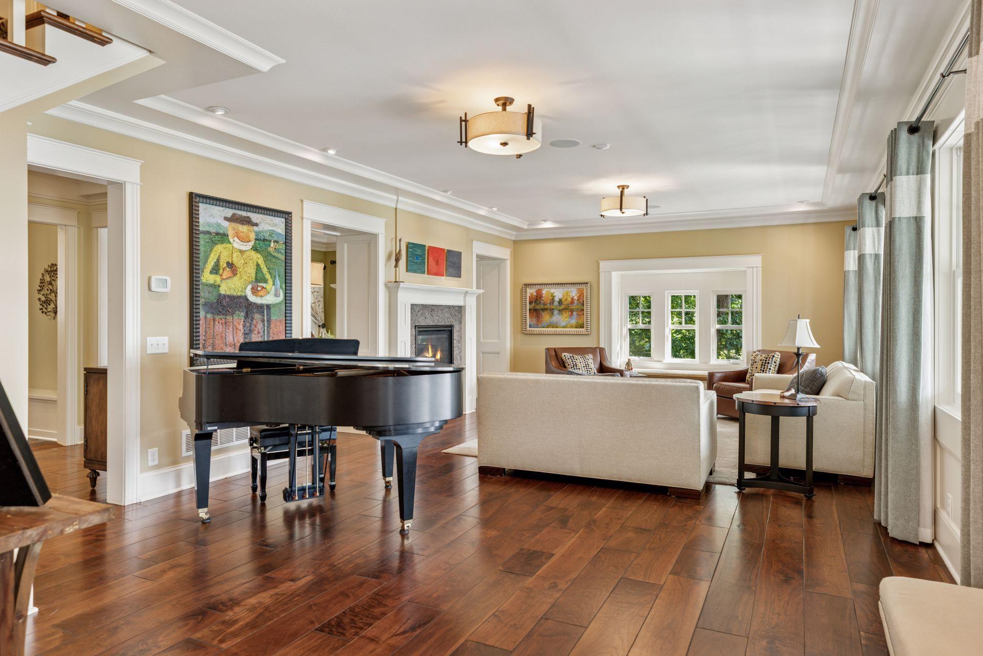 33x16 Fully Renovated Main Level Living room with new south and west facing Marvin Ultimate wood windows, 8-inch solid walnut floors, custom enameled wood work, custom staircase, and double-sided Gas Fireplace.