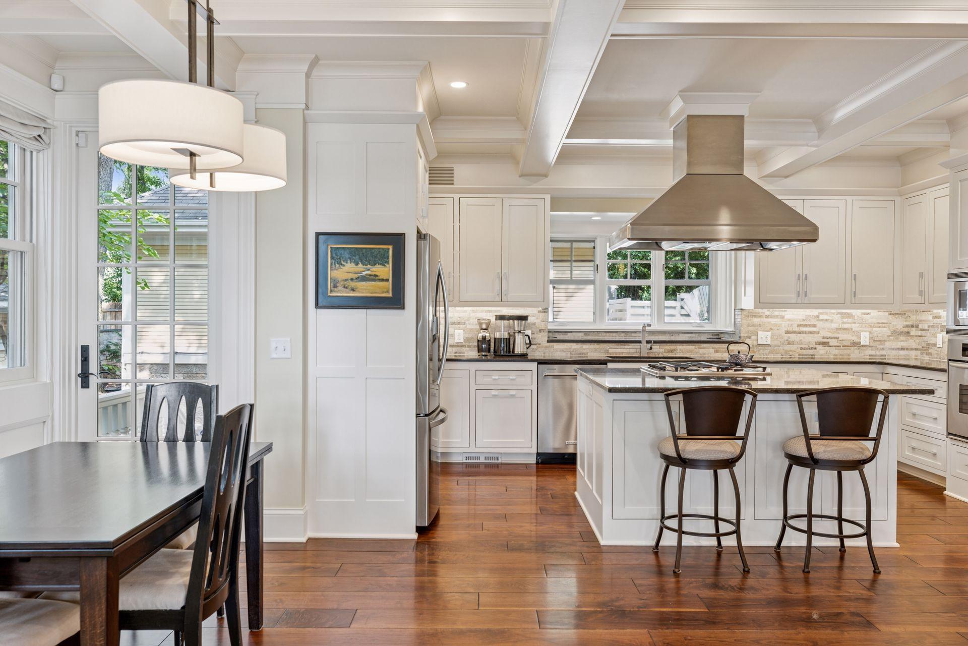 33x24 Fully Renovated Main Level Kitchen with new east, west and north-facing Marvin Ultimate wood windows, 8-inch solid walnut floors, custom enameled Danners cabinetry, coffered ceilings and mill work, Granite countertops and stainless appliances.