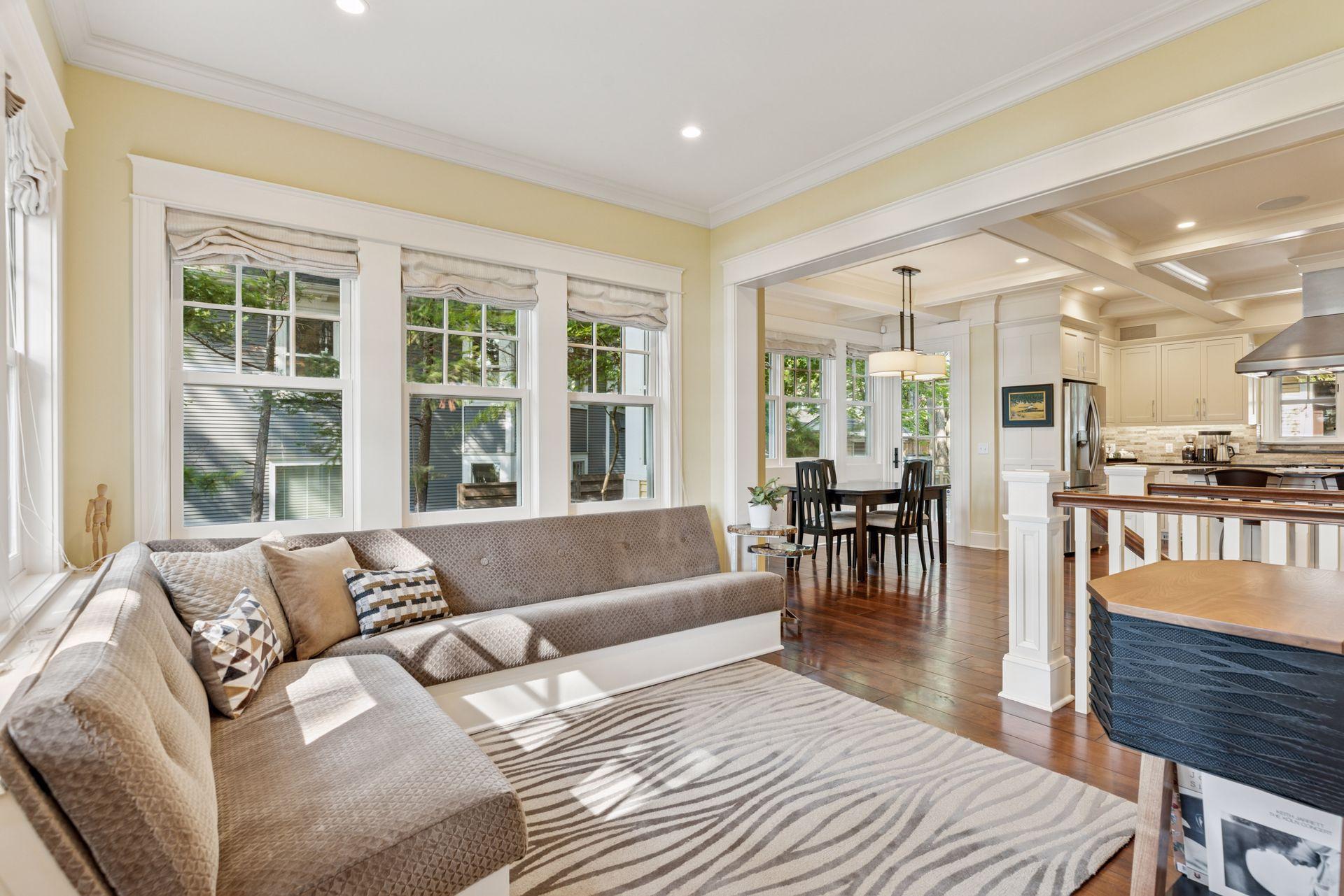 12x11 Fully Renovated Main Level Family room/Sitting room with new west and north facing Marvin Ultimate wood windows, 8-inch solid walnut floors, custom enameled wood work and handmade built-in seating..