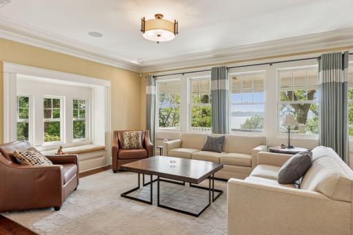 33x16 Fully Renovated Main Level Living room with new south and west facing Marvin Ultimate wood windows, 8-inch solid walnut floors, custom enameled wood work, custom staircase, and double-sided Gas Fireplace.
