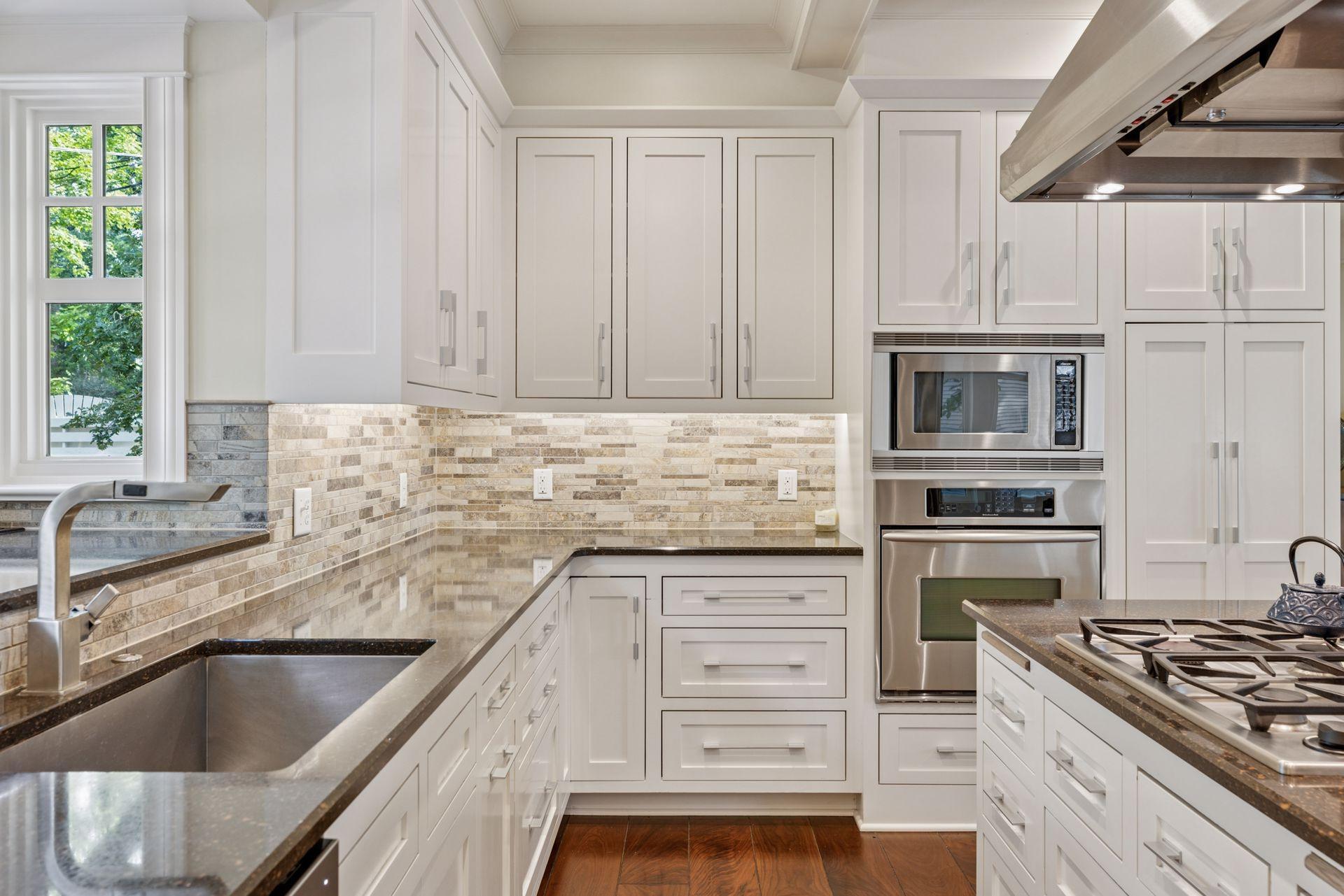 33x24 Fully Renovated Main Level Kitchen with new east, west and north-facing Marvin Ultimate wood windows, 8-inch solid walnut floors, custom enameled Danners cabinetry, coffered ceilings and mill work, Granite countertops and stainless appliances.