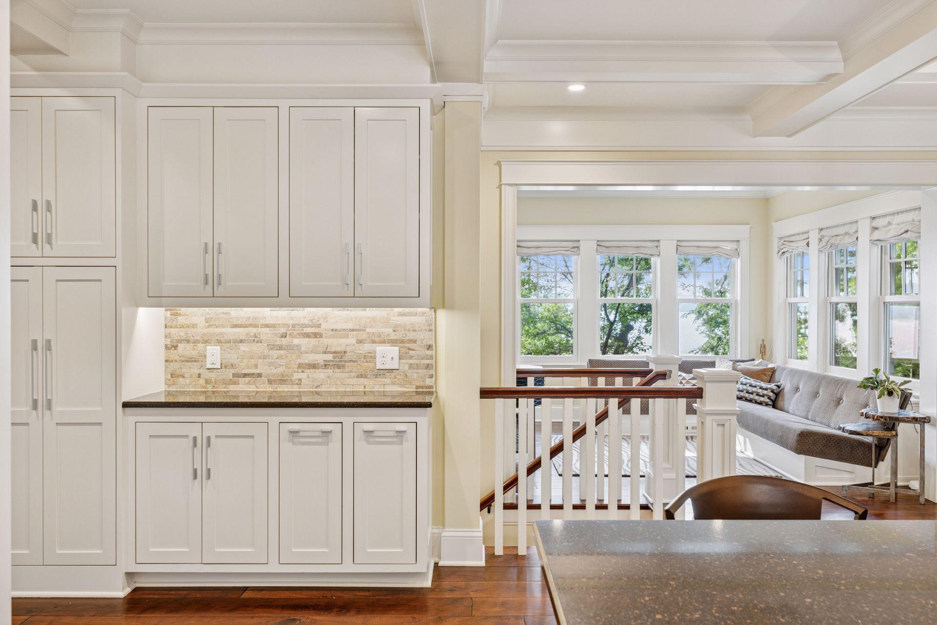 33x24 Fully Renovated Main Level Kitchen with new east, west and north-facing Marvin Ultimate wood windows, 8-inch solid walnut floors, custom enameled Danners cabinetry, coffered ceilings and mill work, Granite countertops and stainless appliances.