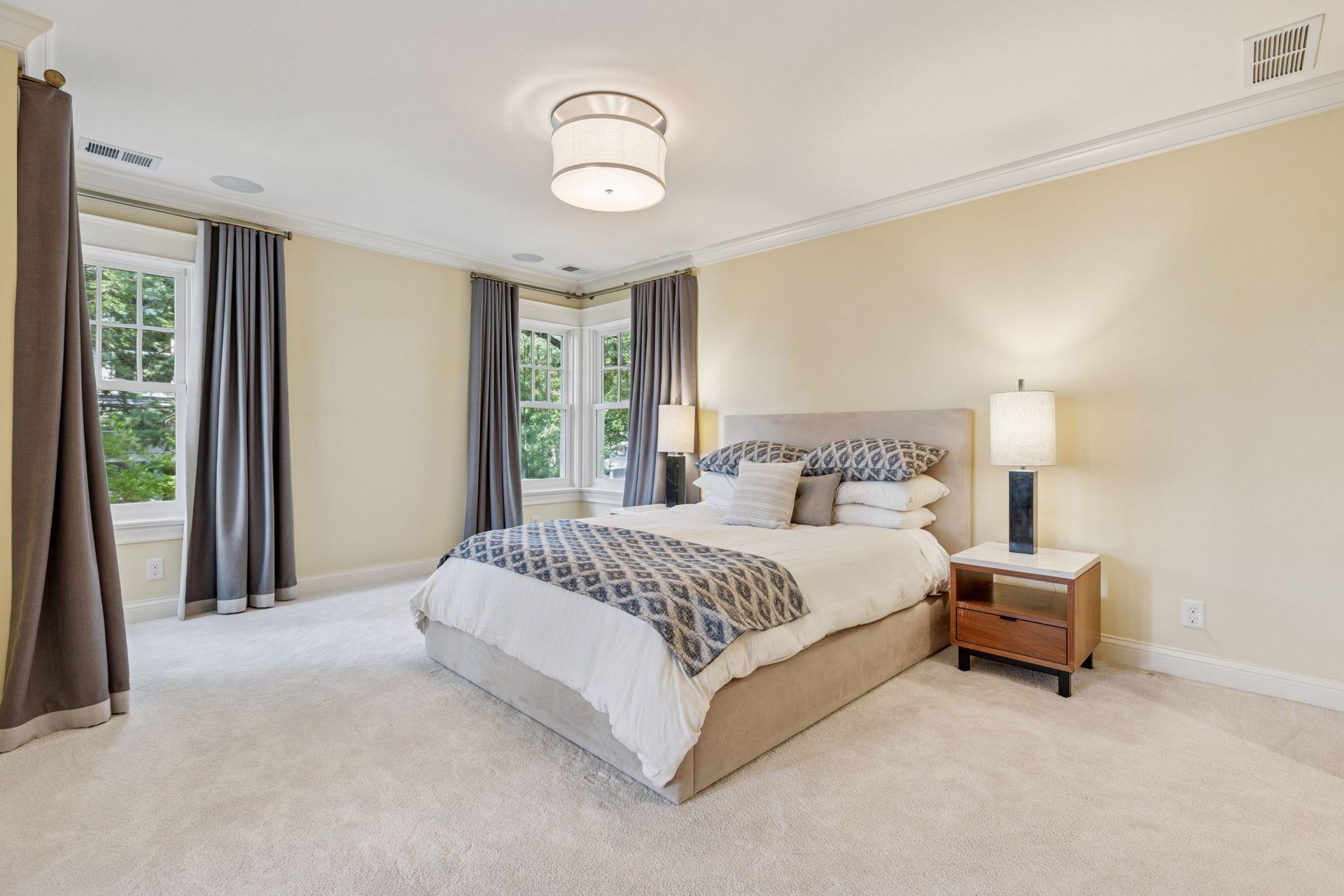 28x13 Fully renovated Primary bedroom with Marvin Ultimate wood windows, custom enameled millworker wool carpeting and frosted pocket doors to the west-facing attached sitting room. West north and east-facing windows.