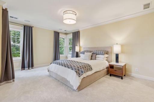 28x13 Fully renovated Primary bedroom with Marvin Ultimate wood windows, custom enameled millworker wool carpeting and frosted pocket doors to the west-facing attached sitting room. West north and east-facing windows.