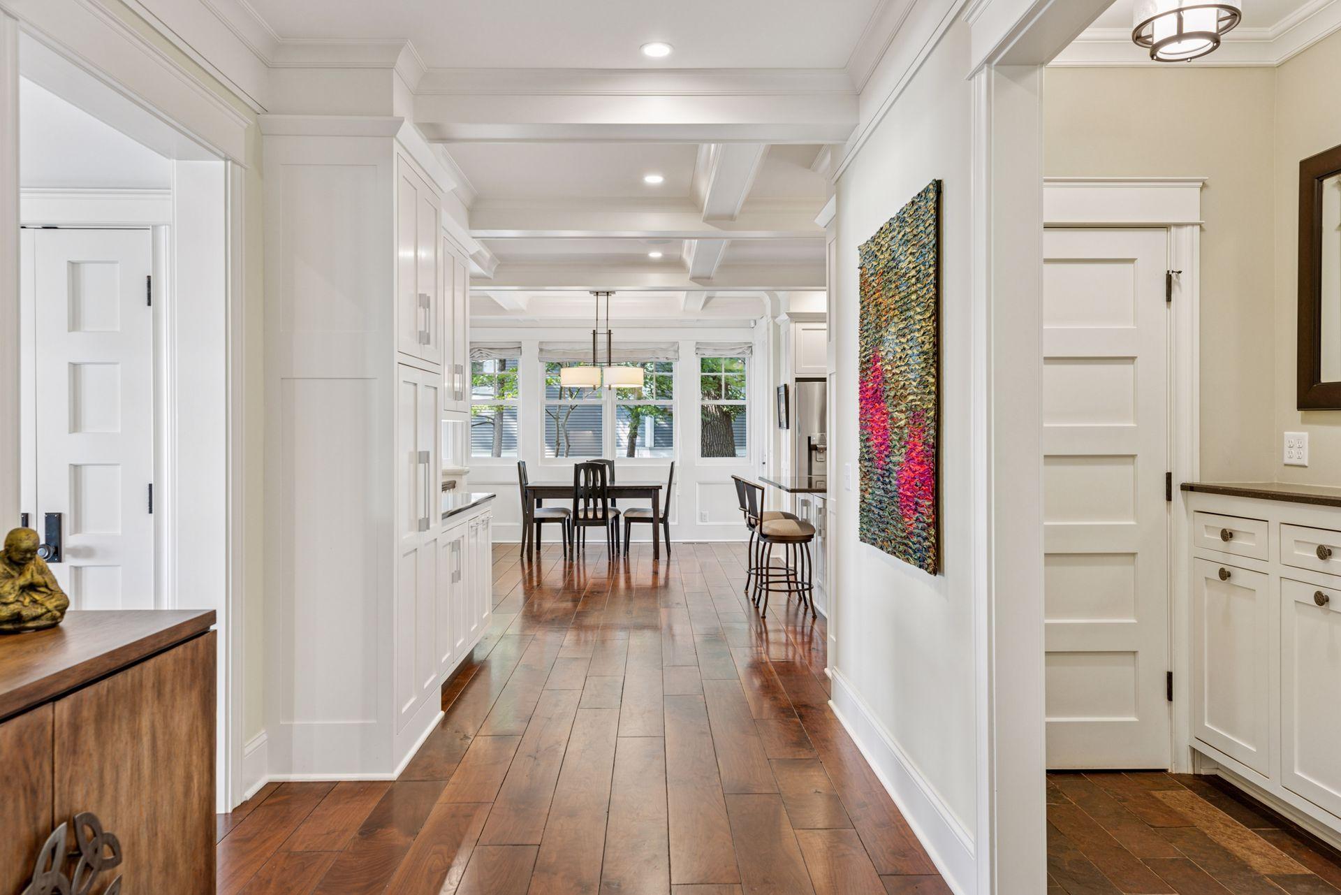 Mid hallway through the main floor showing extra storage and natuarl light throughout the main floor.