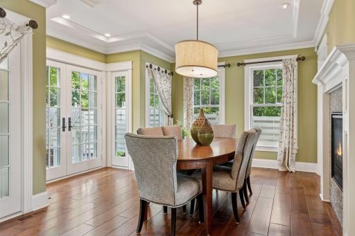 16x15 Fully Renovated Main Level Dining room new east and south-facing Marvin Ultimate wood windows, full glass french doors to the backyard reclaimed paver patio, 8-inch solid walnut floors, custom enameled mill work and double-sided gas fireplace.