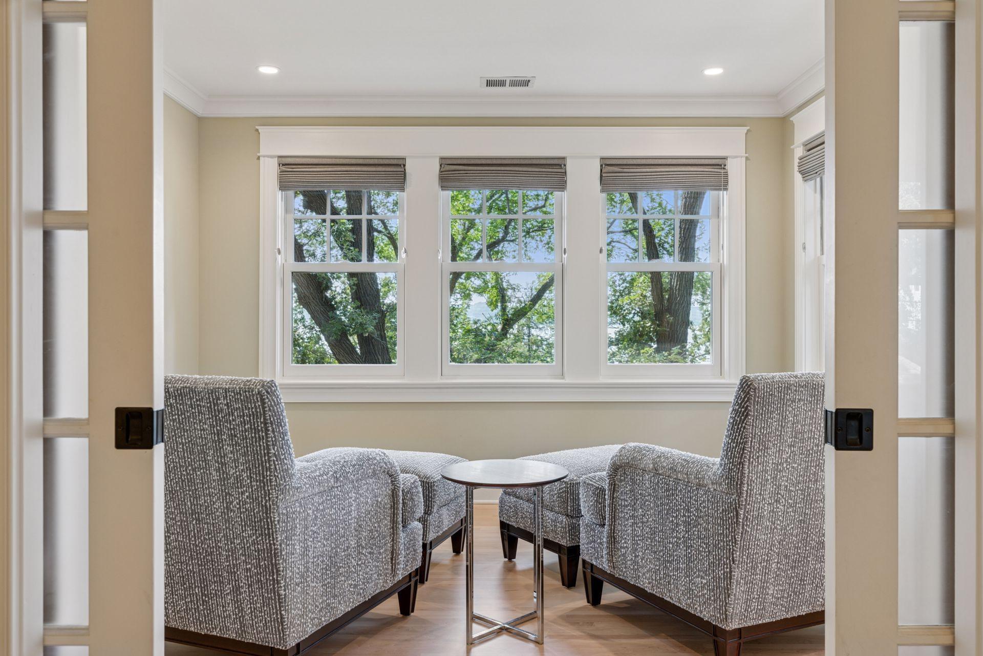 12x11 Fully renovated Primary bedroom-attached sitting room with Marvin Ultimate wood windows, custom enameled millwork and solid walnut floors West and north facing windows.
