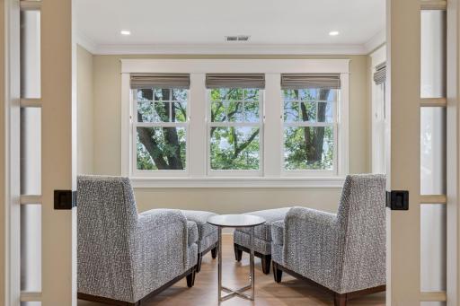 12x11 Fully renovated Primary bedroom-attached sitting room with Marvin Ultimate wood windows, custom enameled millwork and solid walnut floors West and north facing windows.