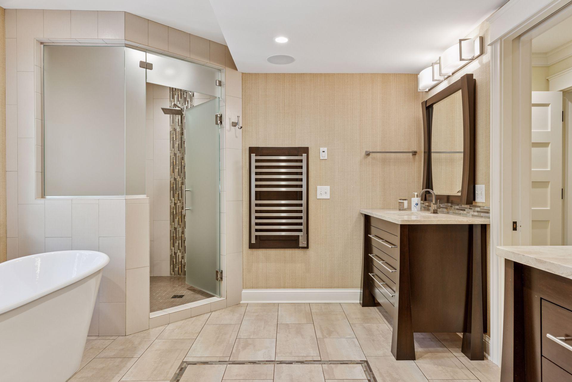 12x11fully renovated Primary bathroom with soaking tub, custom walk in shower, heated towel racks, heated tile floors, double sinks, and attached 12x9 walk in closet. East facing windows.