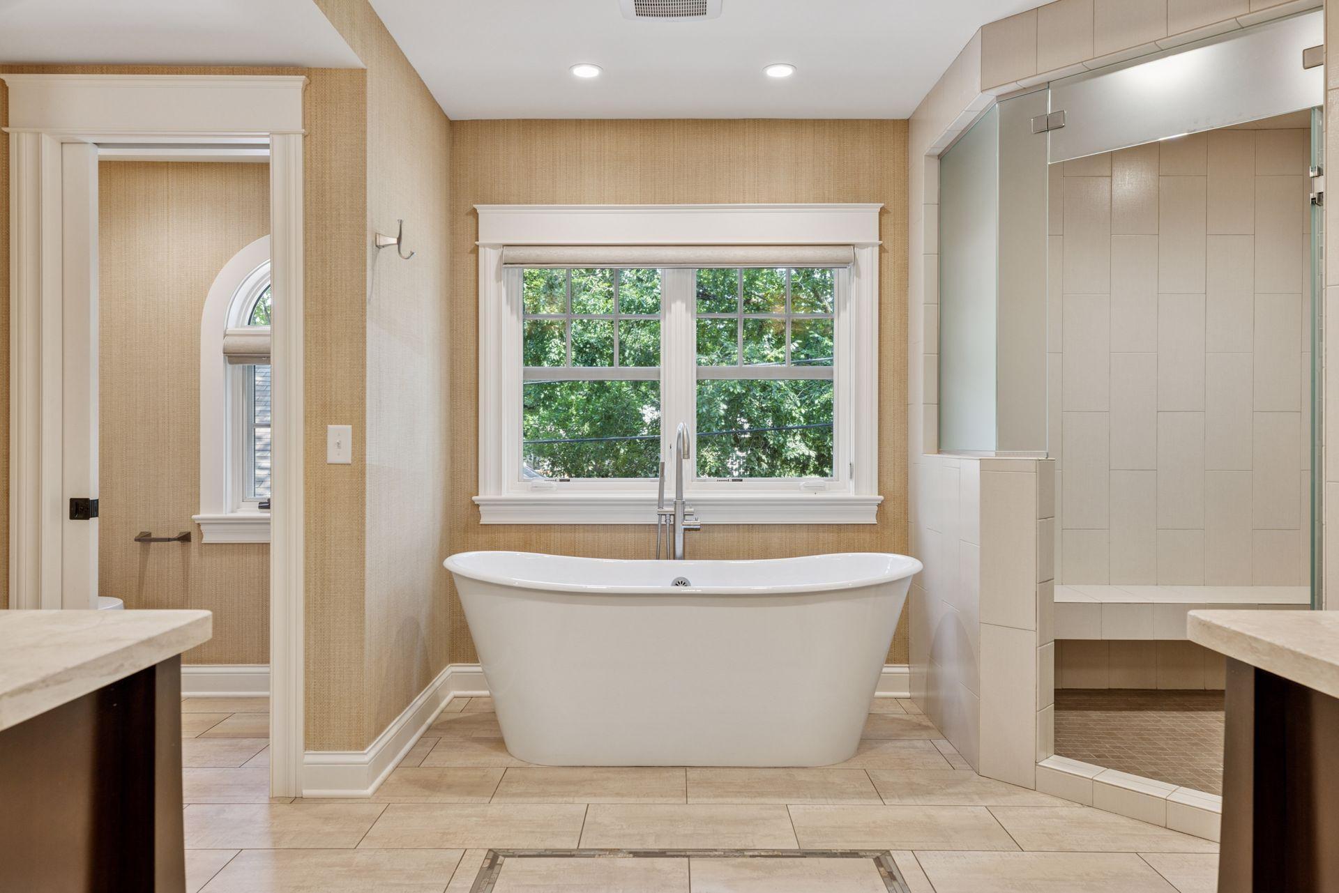 12x11fully renovated Primary bathroom with soaking tub, custom walk in shower, heated towel racks, heated tile floors, double sinks, and attached 12x9 walk in closet. East facing windows.