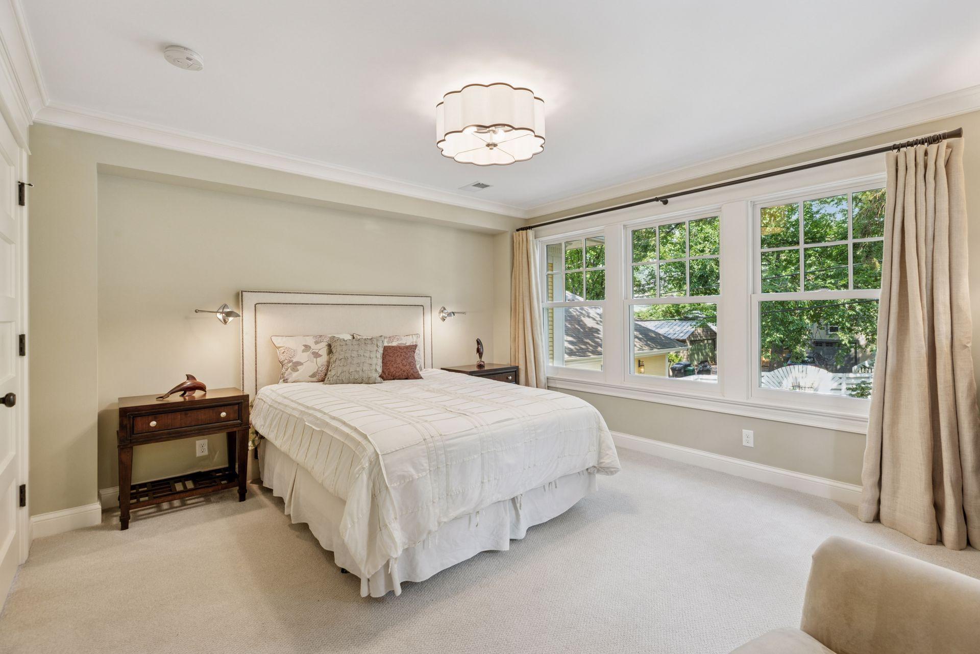 14x12 2nd floor fully renovated Bedroom #2 with wool carpet, enameled millwork, south and east-facing windows.