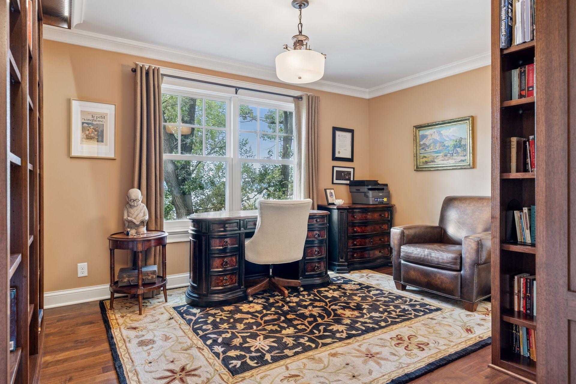 13x12 2nd floor fully renovated Den/Library with 8 inch walnut floors, custom library shelving with built in lighting, enameled millwork and west-facing windows.