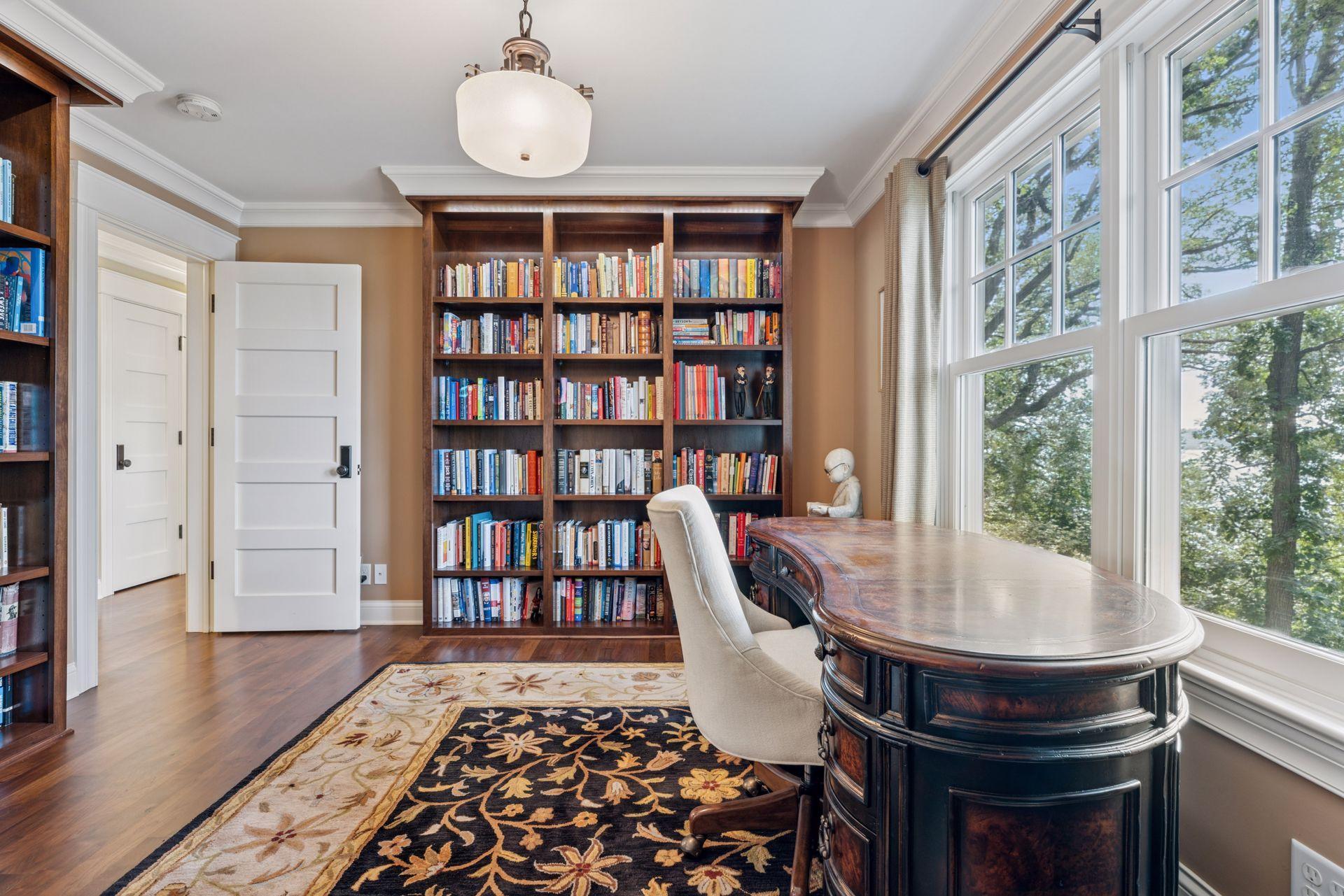 13x12 2nd floor fully renovated Den/Library with 8 inch walnut floors, custom library shelving with built in lighting, enameled millwork and west-facing windows.