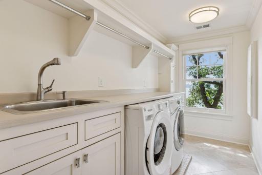 2nd floor fully renovated Laundry room with custom Danners cabinetry, tiled floors, and custom enameled mill work. West-facing windows.