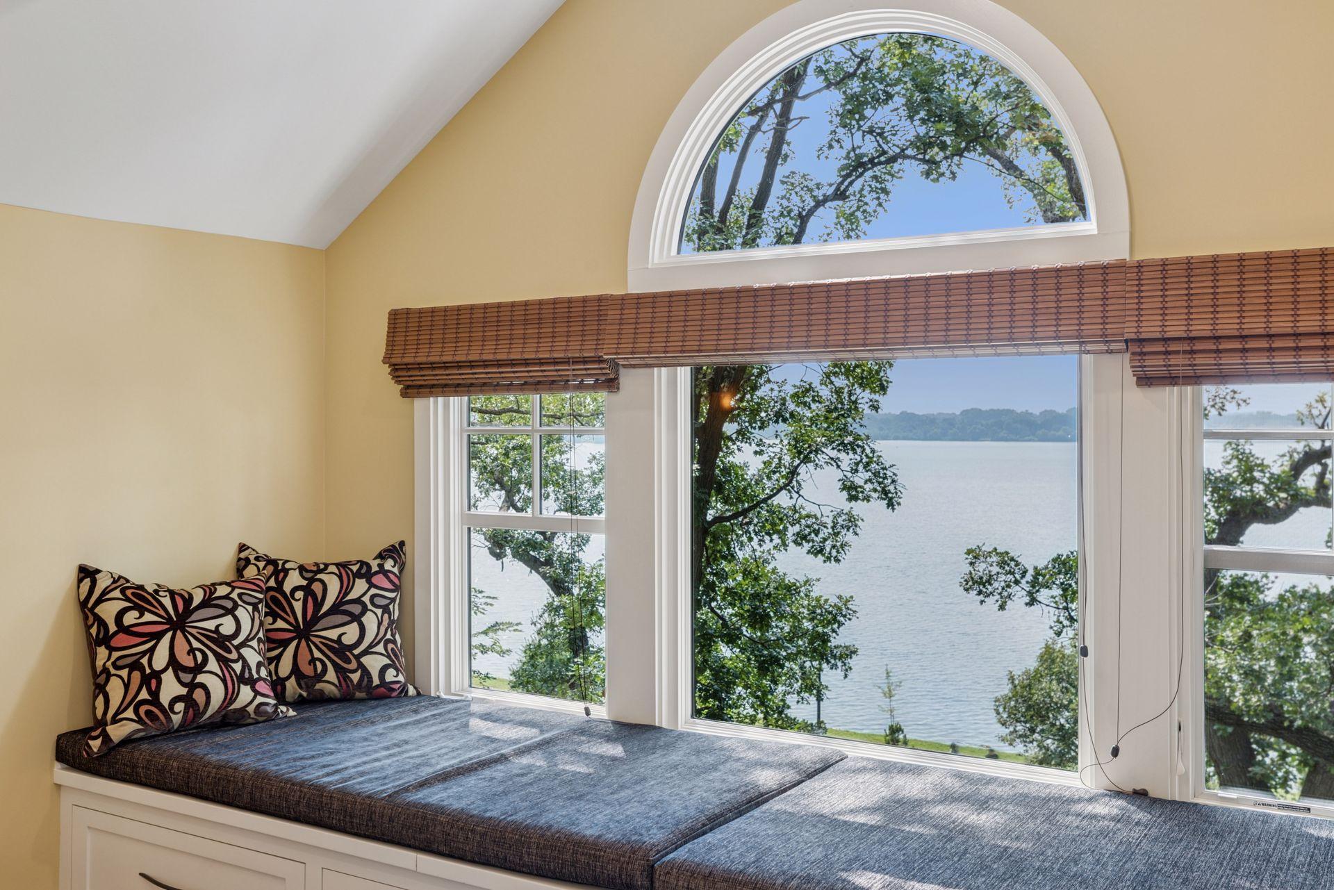 18x15 3rd floor Bedroom #4 with full bathroom suite including soaking tub, fully tiled shower with skylight, enameled millwork, custom built-in cabinetry and seating with west-facing windows of Lake Bde Maka Ska.