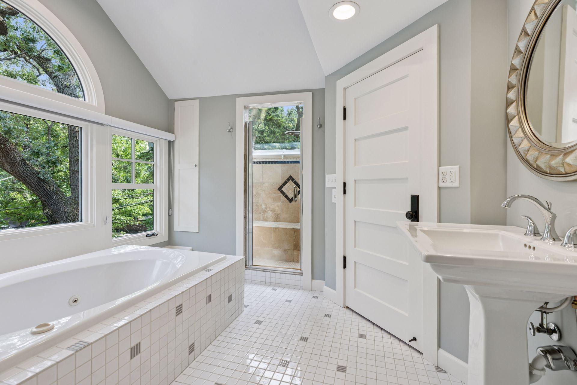 18x15 3rd floor Bedroom #4 with full bathroom suite including soaking tub, fully tiled shower with skylight, with east-facing windows.