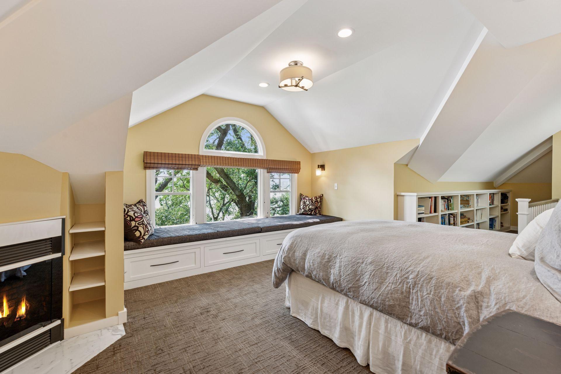 18x15 3rd floor Bedroom #4 with full bathroom suite including soaking tub, fully tiled shower with skylight, enameled millwork, custom built-in cabinetry and seating with west-facing windows of Lake Bde Maka Ska.