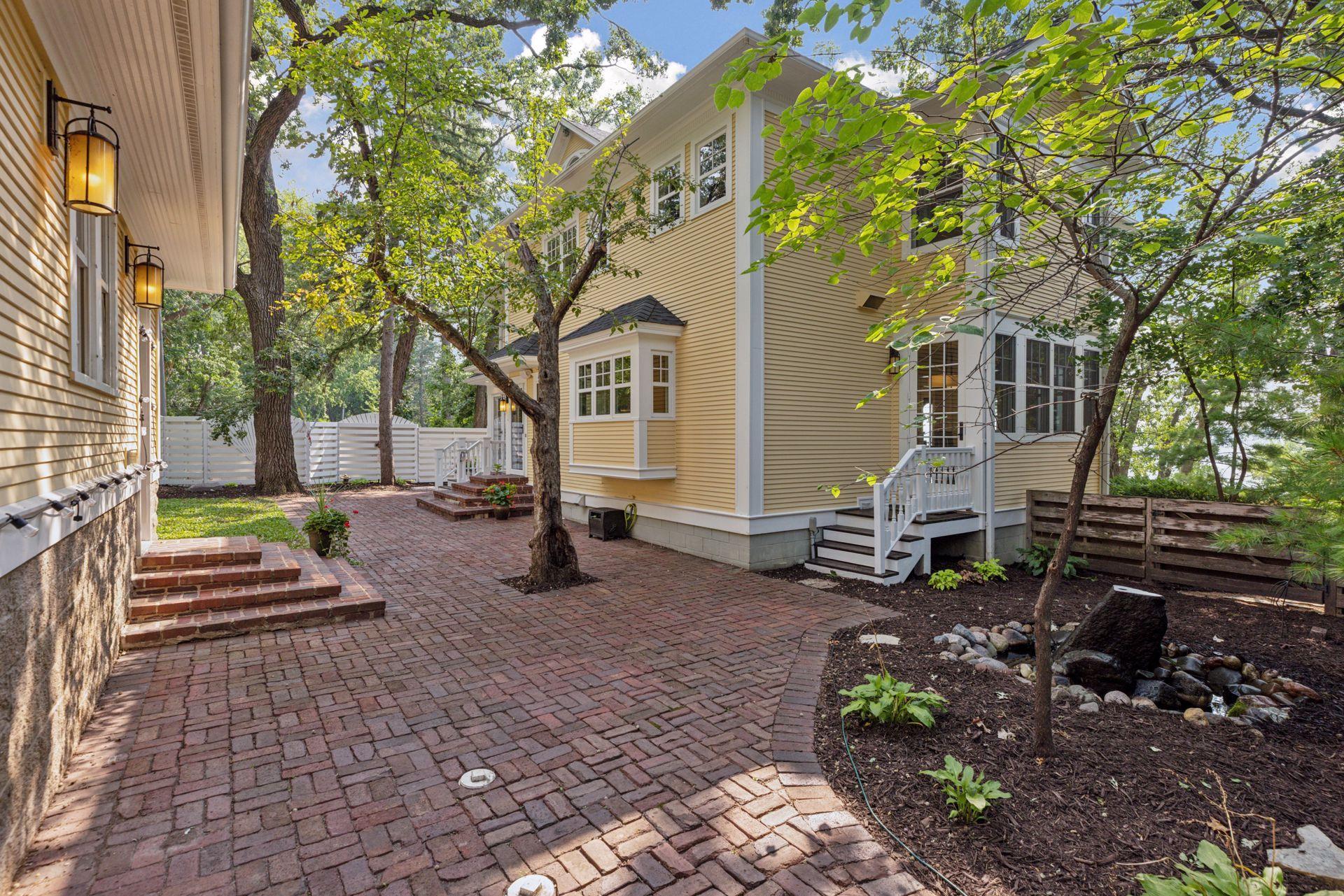 Fully fenced in back yard with reclaimed paver patio, professional landscaping, irrigation system, and water feature creates an amazing private oasis in the city for relaxing or entertaining.