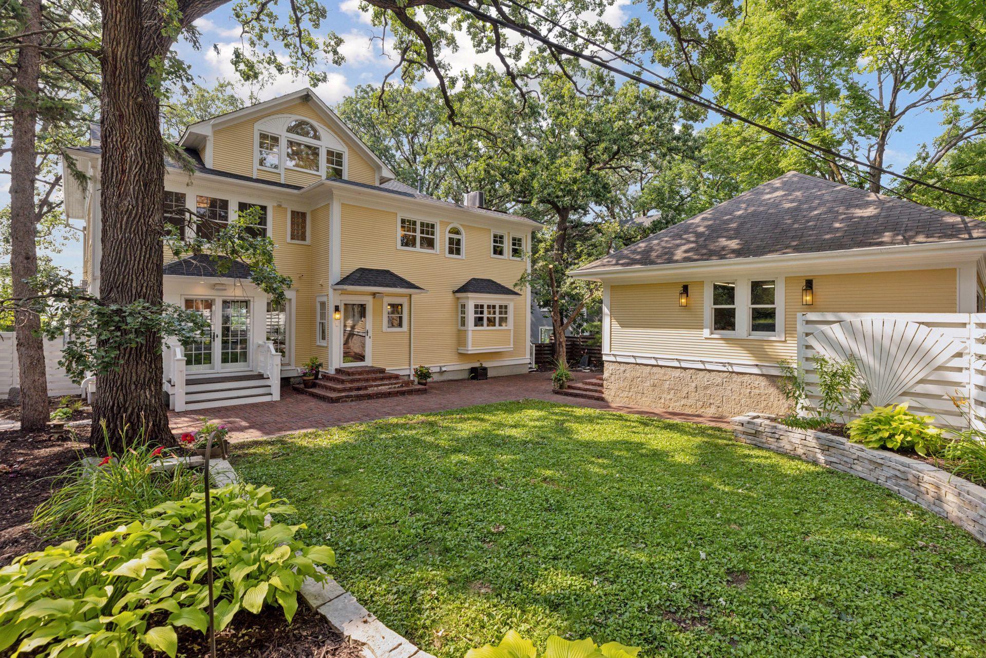 Fully fenced in back yard with reclaimed paver patio, professional landscaping, irrigation system, and water feature creates an amazing private oasis in the city for relaxing or entertaining.