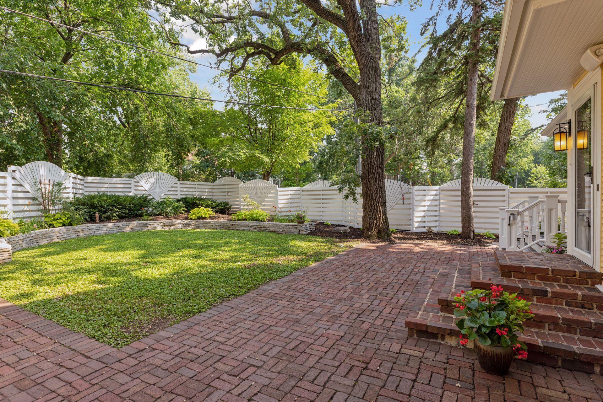 Fully fenced in back yard with reclaimed paver patio, professional landscaping, irrigation system, and water feature creates an amazing private oasis in the city for relaxing or entertaining.
