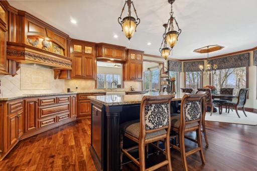 Take in the gorgeous views from your gourmet kitchen highlighted with American cherry custom cabinetry, walnut floors, top of the line appliances and beautiful light fixtures