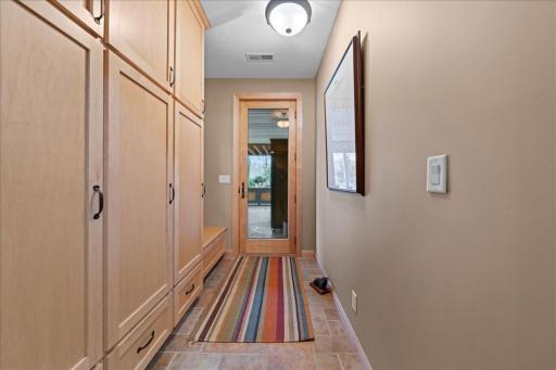 Lower level mudroom area leading to stamped concrete patio and pool area.