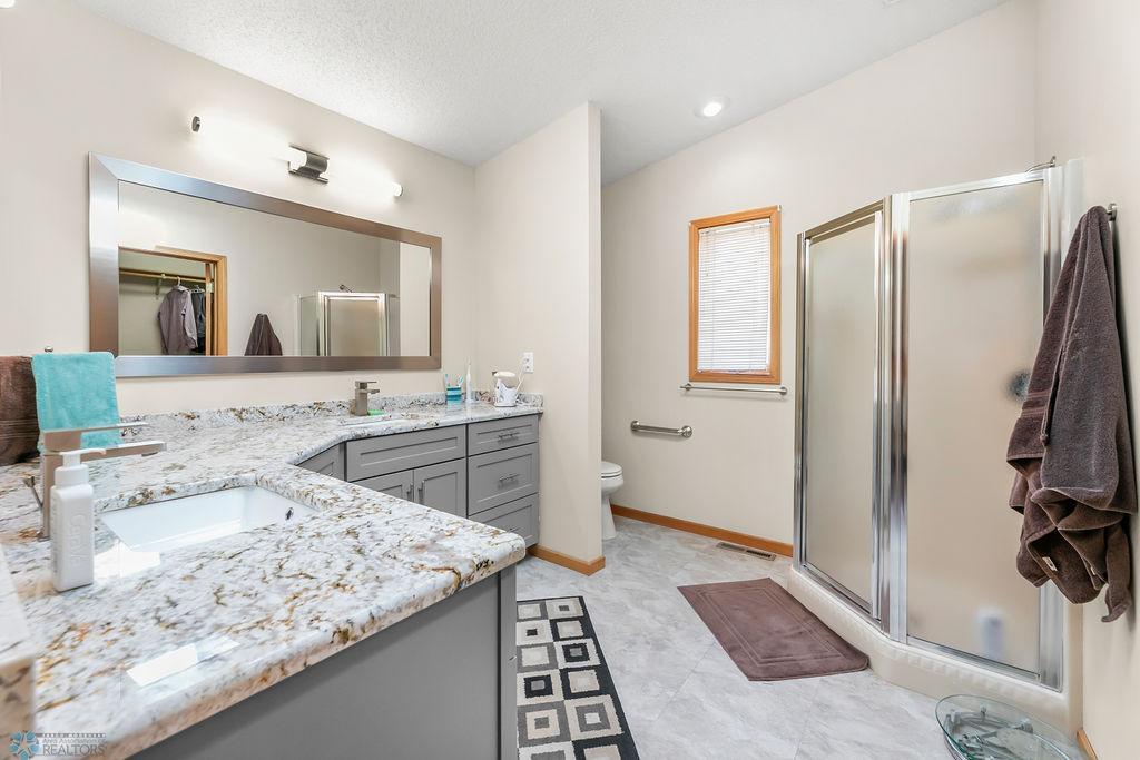 Walk-in shower. Quartz counters. Recessed lighting.