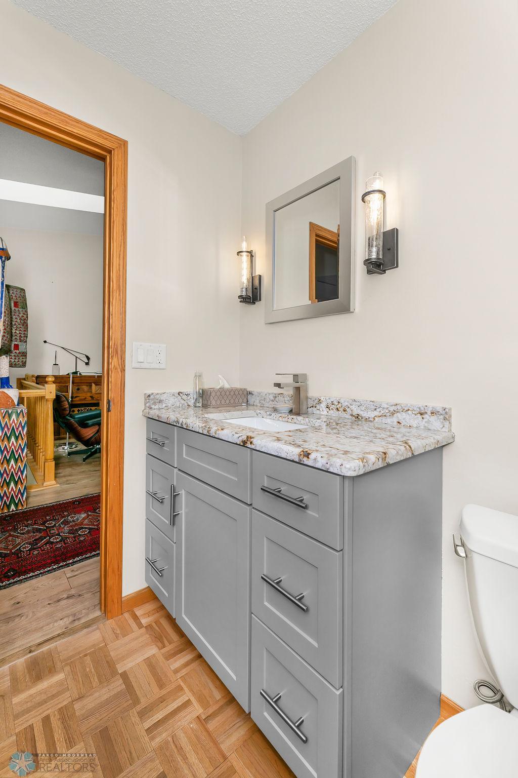 Spacious half bath with Quartz counter & modern fixtures