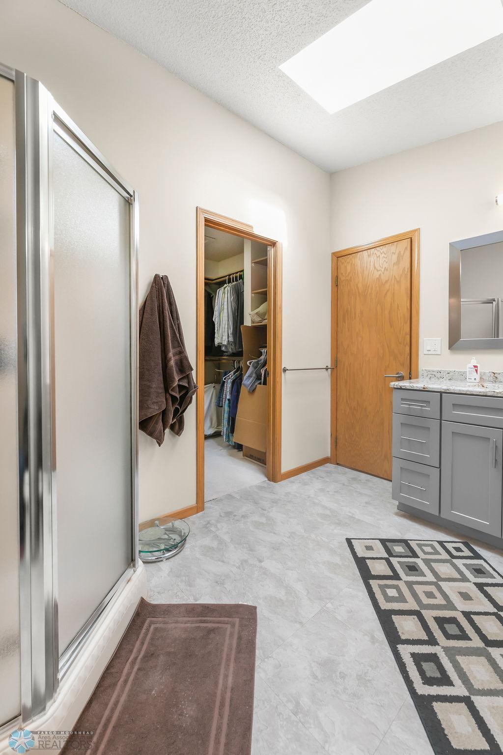 Bathroom has large skylight. View to Walk-in Closet