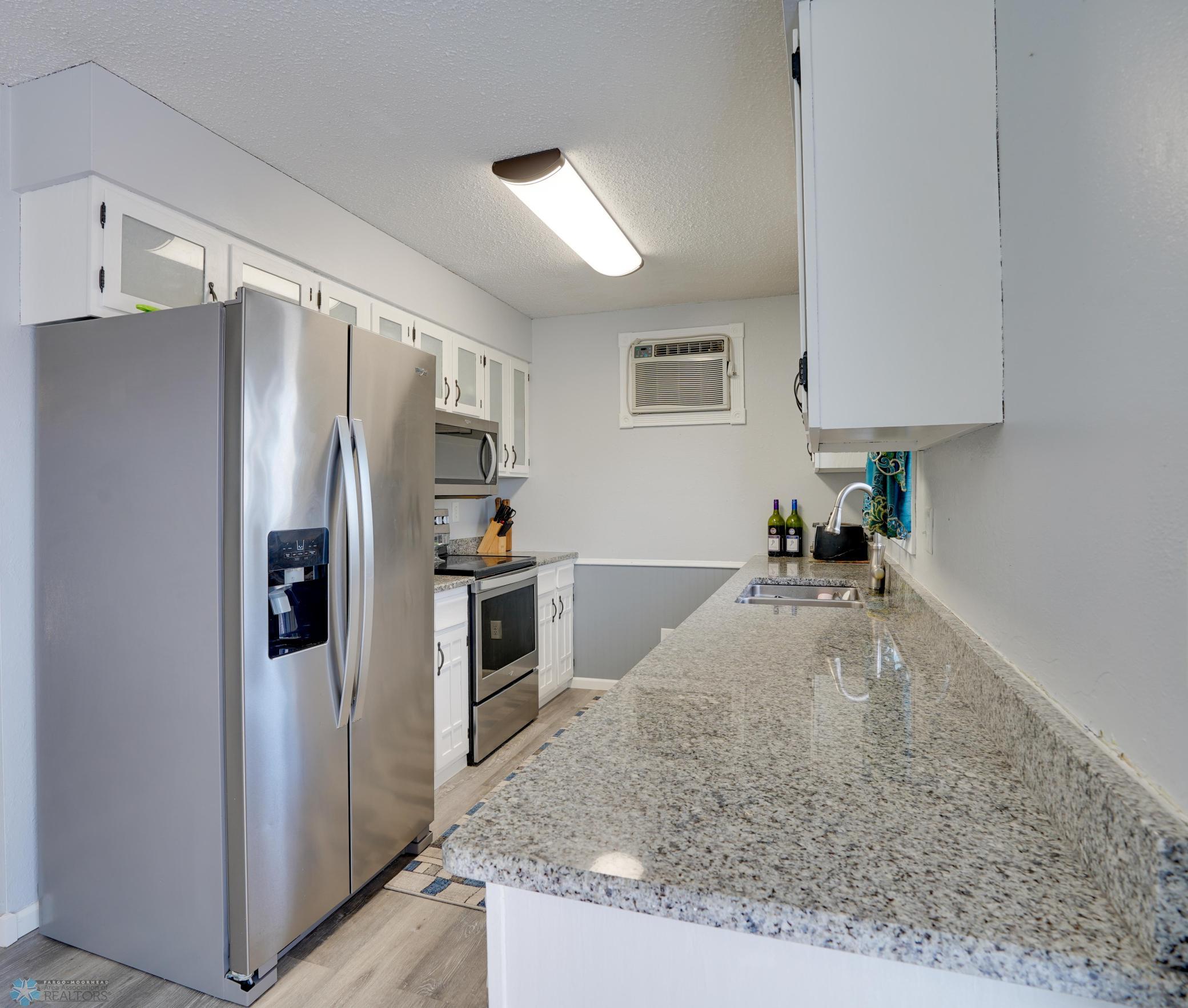 All-white kitchen w/ stone counters, S/S appliances