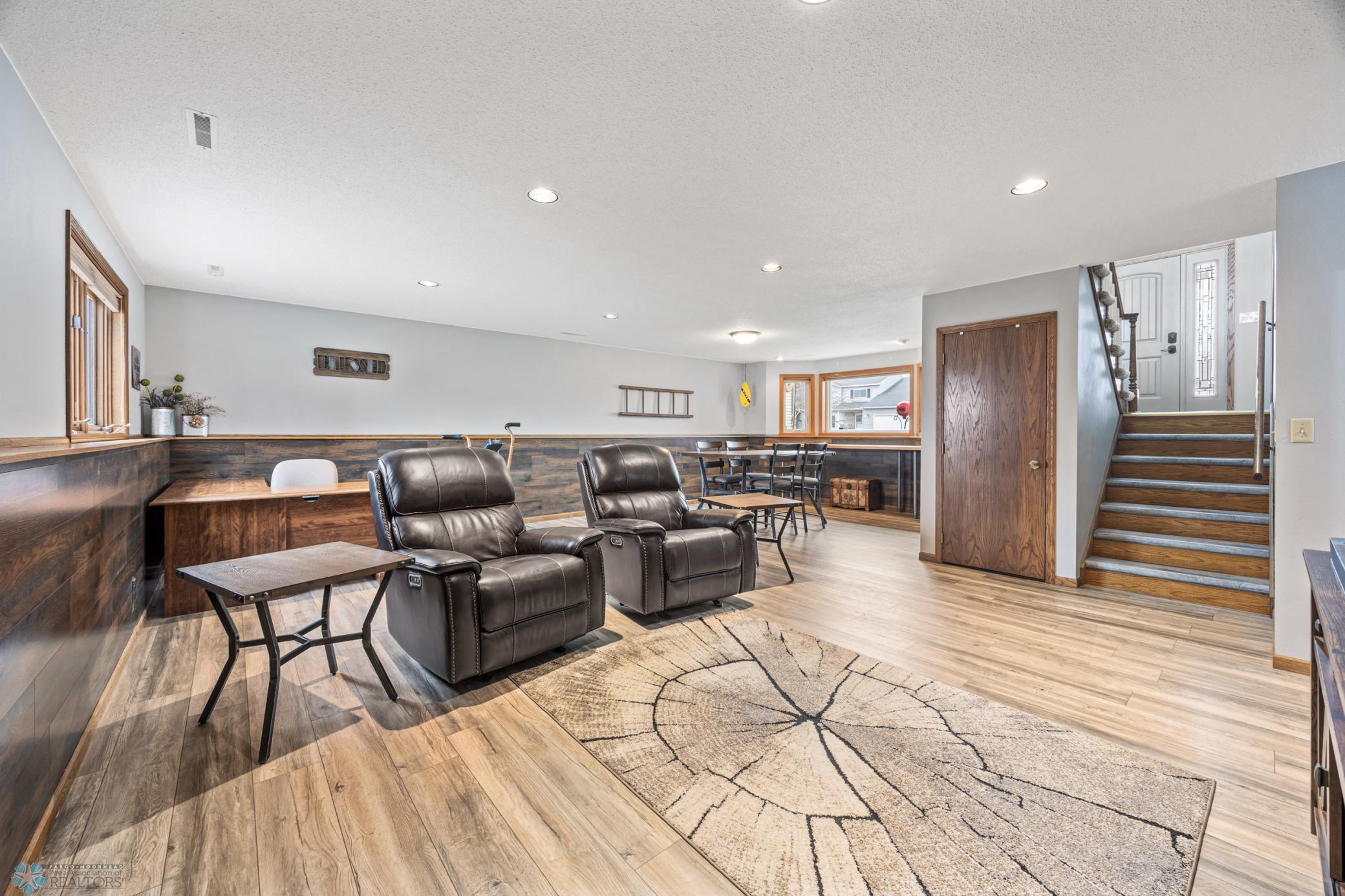 BIG lower level family room - with laminate flooring & bay window
