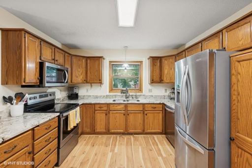Spacious kitchen with loads of cabinets, SS appliances, gorgeous granite counter-tops pantry, & window facing the back yard.